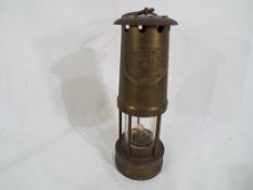 An E Thomas & Williams Ltd brass bodied miners lamp, Cambrian type marked No 157448.