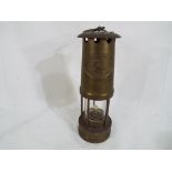 An E Thomas & Williams Ltd brass bodied miners lamp, Cambrian type marked No 157448.