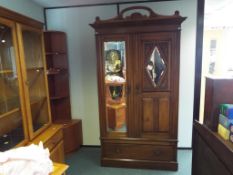 A good mahogany two-door wardrobe, the doors with bevel-edged mirrors,