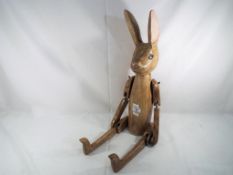 A good quality carved wooden jointed rabbit, 75 cm (h).