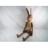 A good quality carved wooden jointed rabbit, 75 cm (h).