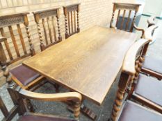 An oak dining table with six matching chairs and two carvers,