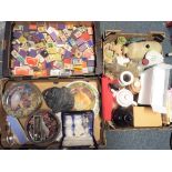 Three boxes containing a quantity of glassware, ceramics, ornamental cottages, foot warmer,