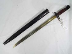 A British 1907 Pattern Bayonet, and Scabbard. The blade is stamped with a crown over "G.R.