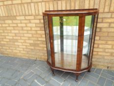 A good quality glass bow fronted display cabinet,
