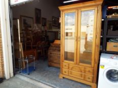 A glass two-door display cabinet with three glass shelves and two drawers marked Fran-San,
