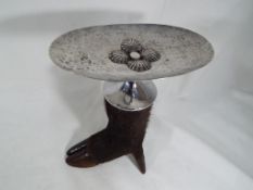 A shallow white metal dish mounted on a boar's foot, approximate height 20 cm (h),
