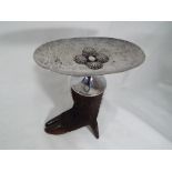 A shallow white metal dish mounted on a boar's foot, approximate height 20 cm (h),