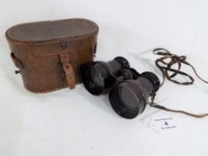 A pair of good quality English made binoculars with leather strap and holding grip,