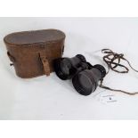 A pair of good quality English made binoculars with leather strap and holding grip,