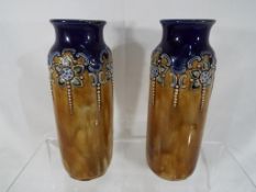 Royal Doulton - a pair of Royal Doulton Lambeth Ware vases with relief decoration, approx 16.
