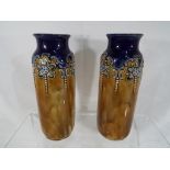 Royal Doulton - a pair of Royal Doulton Lambeth Ware vases with relief decoration, approx 16.