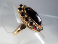 An 18ct yellow gold stone set ring with large centre stone and surrounding stones stamped 585 size