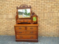A good quality chest of drawers, the gallery above having a swivel bevelled edge mirror,