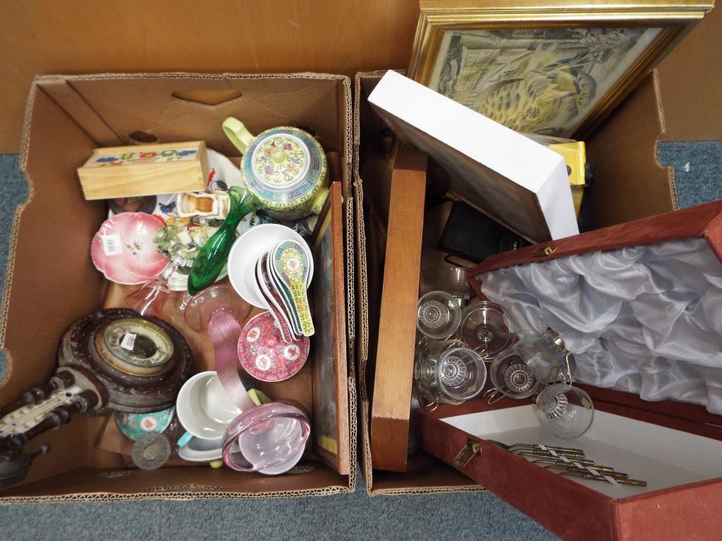 A good mixed lot comprising two boxes to include ceramics, prints, cameras, glassware,