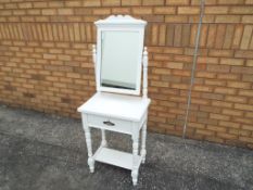 A dressing table with mirror, painted white,