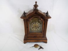 An early 20th century beech cased bracket style clock,