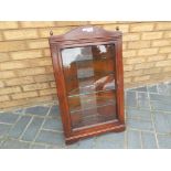 A mahogany glass fronted wall corner uni