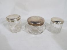 Three dressing table jars with sterling