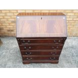 A mahogany bureau, the slope front openi