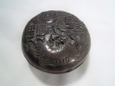 An Asian white metal lidded pot depictin