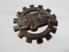 A pin badge depicting a German VW Beetle