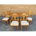 A dining table and 4 chairs and 2 carver
