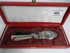 A silver handled shoehorn, horn marked I