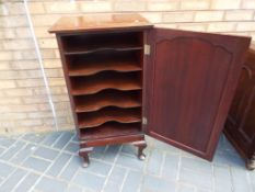 A mahogany music cabinet on cabriole sup