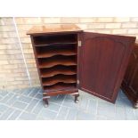 A mahogany music cabinet on cabriole sup