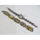 A lady's marcasite covered face bracelet wristwatch marked Picador to the face and an unusual