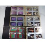 Elvis - Three binders containing approximately six hundred collector / trading cards relating to