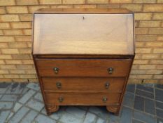A drop fronted bureau over three drawers, approximate height 97 cm x 74 cm x 39 cm.