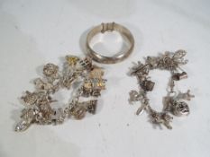 A good collection of silver jewellery comprising a hallmarked silver charm bracelet containing