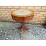 A leather top drum table,
