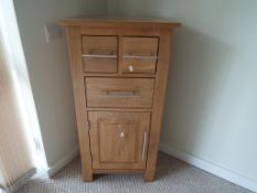 Oak Furniture Land - a three drawer storage unit,