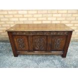 A highly carved oak coffer 57 cm x 105 cm x 46 cm.