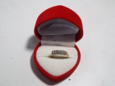 A 14 carat gold ring set with five diamonds stamped 14k, size M, approximate weight 2.