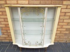 A mid 20th century serpentine fronted display cabinet by Denmor Furniture Co