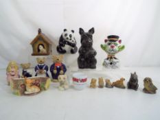 A collection of mixed ceramics to include Wade money banks and whimsies,