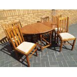 A good quality drop leaf oak dining table on barley twist support,