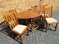 A good quality drop leaf oak dining table on barley twist support,