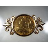 A Victorian gold sovereign dated 1897 set in 9ct gold mount as a brooch, total weight 11.