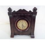 A mahogany cased wind-up alarm clock, Arabic numerals on a white dial with two subsidiary dials,