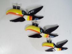 Three flying toucan Guinness wall plaques marked Carlton Ware (3).