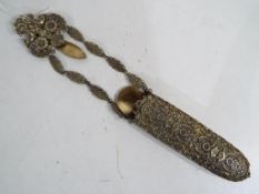 A chatelaine spectacles case with relief decoration.