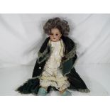 An early 20th century German dressed doll dating to ca 1908, bisque head, cloth body,