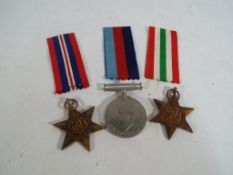 Three World War II (WW2) medals with ribbons, boxed.