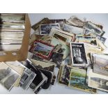 A collection of over 600 UK, foreign and subject postcards to include real phototypes,