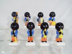 Eight ceramic Golly Band figurines marked Carlton Ware, approximate height 7.